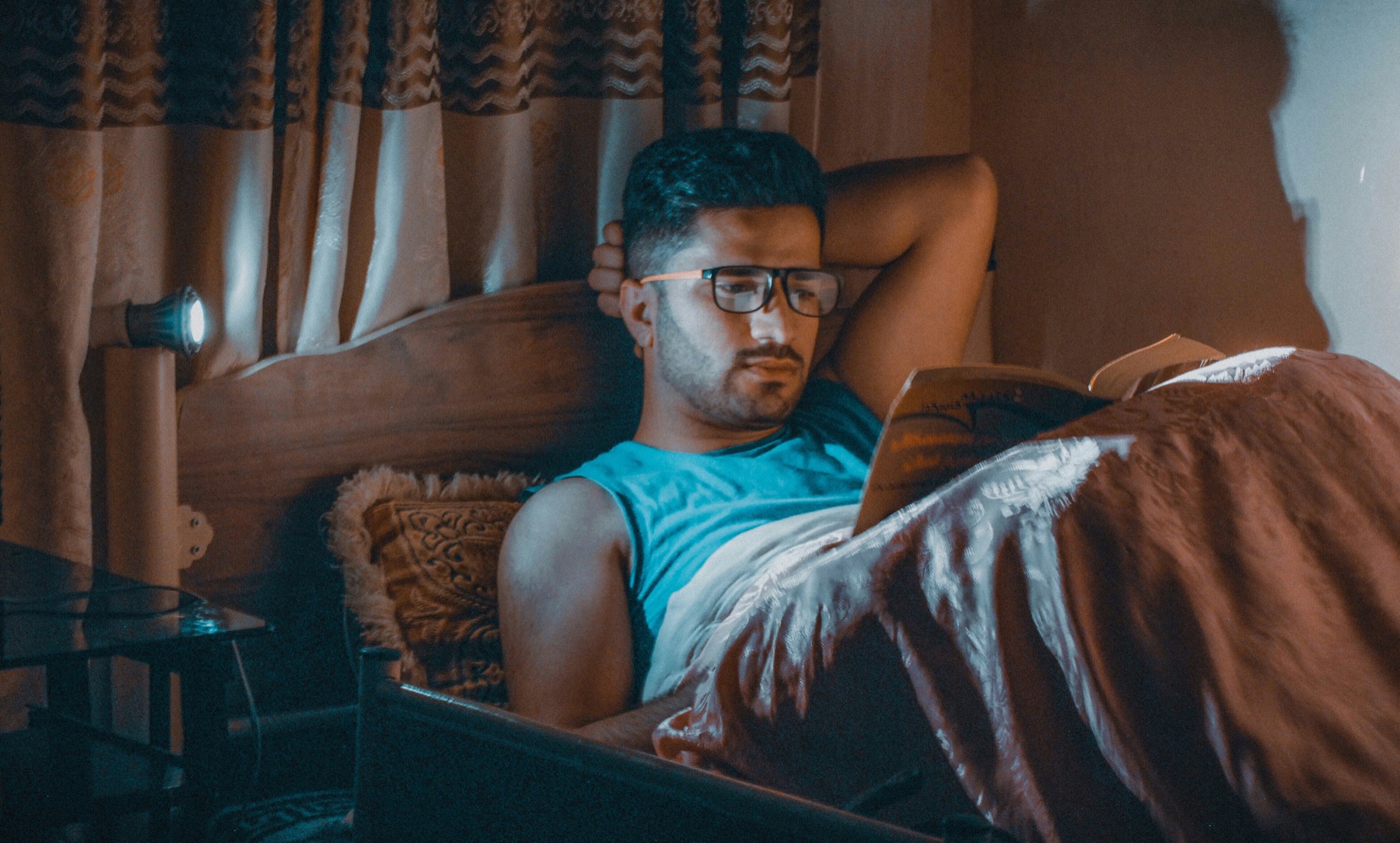 person reading in dim light after waking up at night